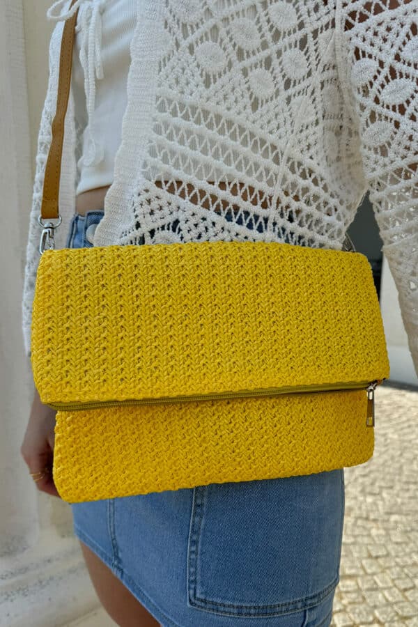 Sommerliche geflochtene Clutch-Tasche mit stilvollem Flechtdesign in gelb. Die Tasche verfügt über einen sicheren Reißverschluss und zusätzlichen Magnetverschluss. Dank des abnehmbaren und verstellbaren Schulterriemchens kann sie flexibel als Clutch oder Umhängetasche getragen werden. Leichtes, modisches Accessoire für Alltag, Urlaub und sommerliche Outfits.