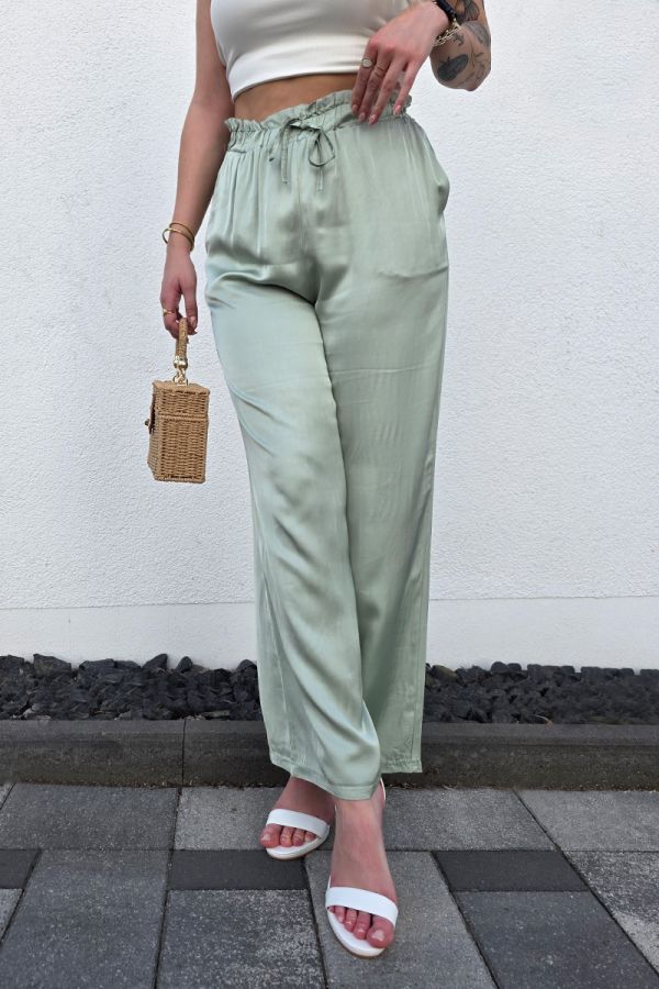 Diese edle Hose in Satin-Optik in einem eleganten Olivton überzeugt mit einem hohen, elastischen Paperbag-Bund und einem lockeren, weiten Schnitt, der luftig und bequem sitzt. Seitliche Eingrifftaschen sorgen für praktische Details, während das fließende Material einen femininen Look unterstreicht. Ideal kombinierbar mit einem Bandeau-Top und Sandaletten für einen lässig-eleganten Casual Chic Style.